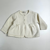 Cardigan newborn latte con fiocchetti DK117